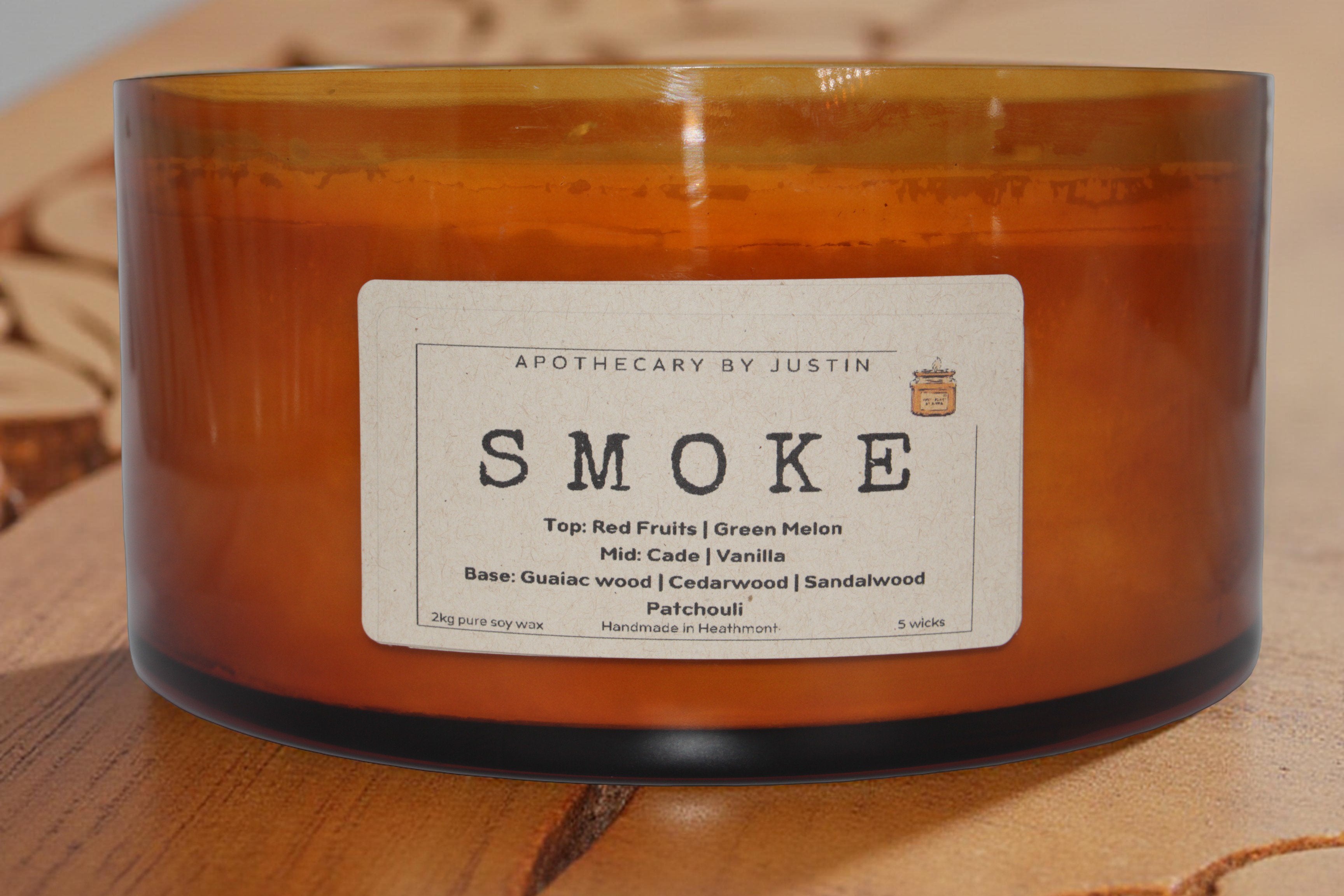 Eco-friendly amber candles collection featuring vegan soy wax in a wooden display with lemon scent