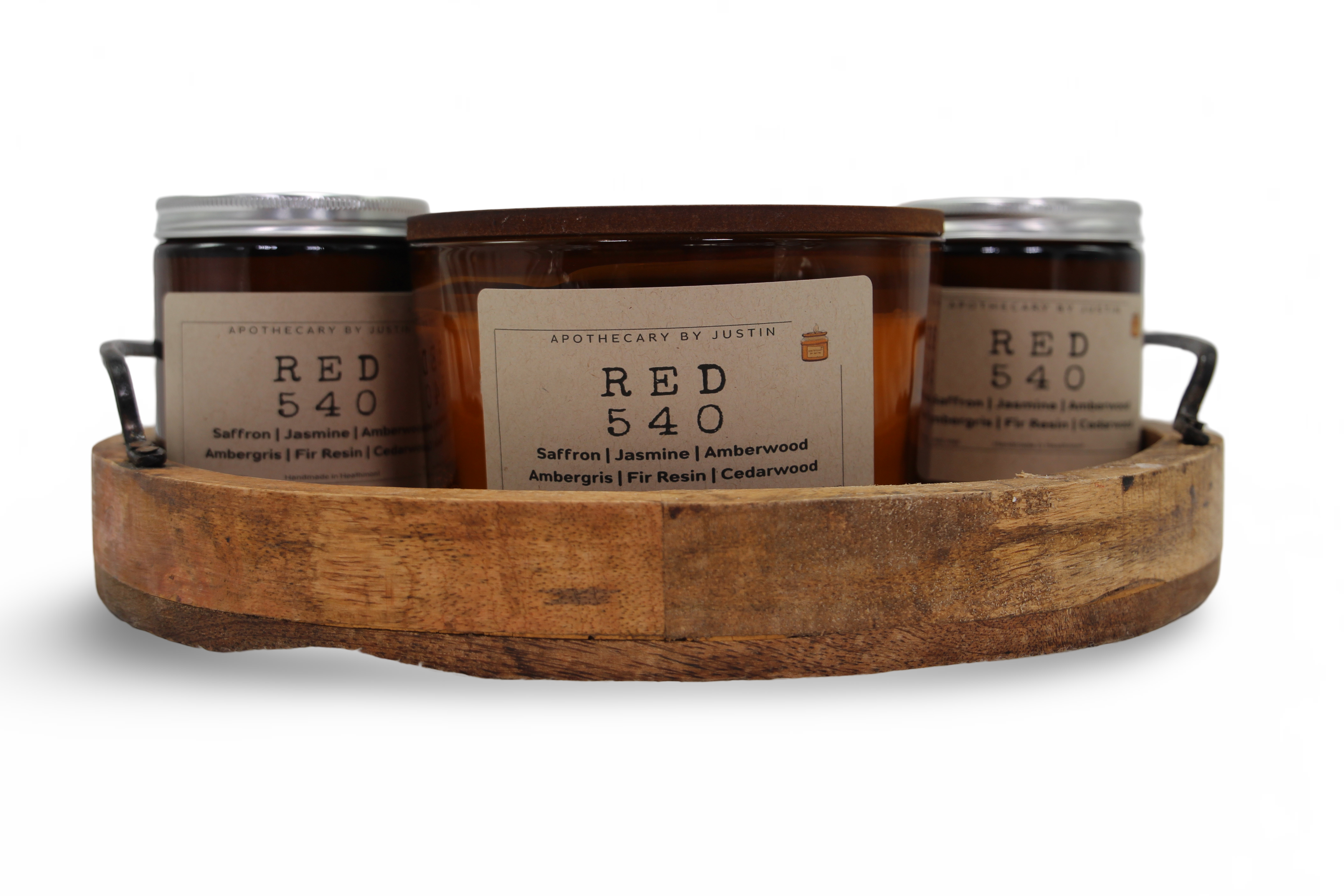 Three hand-poured scented candles in a wooden tray featuring saffron, jasmine, and amberwood scents