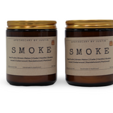 Two My Store additive-free soy wax candles in amber jars with golden lids, featuring smoky scents