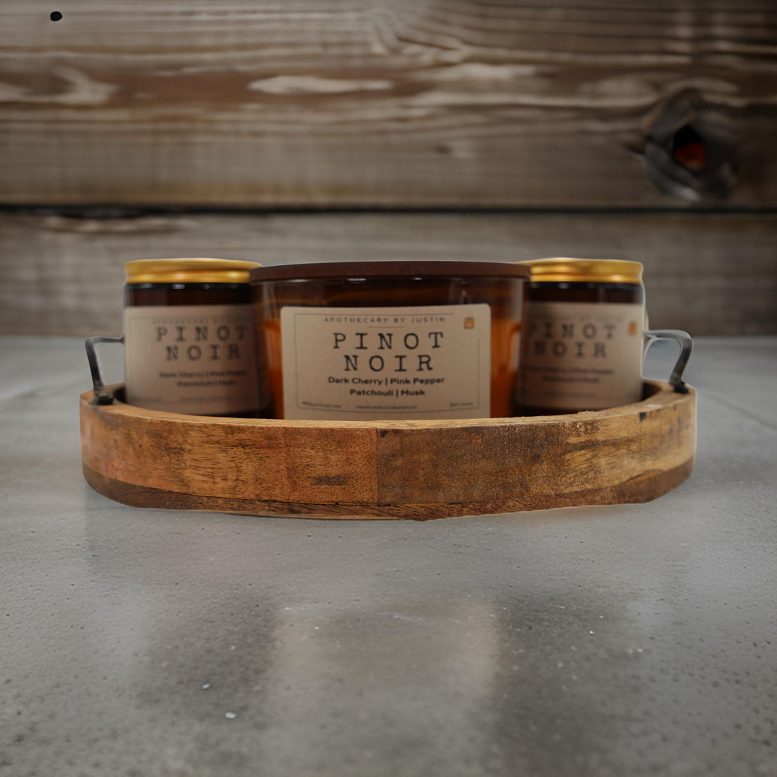 Set of Pinot Noir candles featuring dark cherry fragrance candle housed in a rustic wooden holder