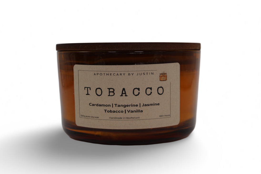 Hand-poured aroma candle in an amber jar with Tobacco, Cardamom, and Jasmine scents for a soothing ambiance