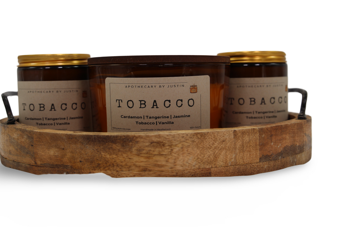 Hand-poured aroma candle set in a wooden tray featuring Tobacco scent with various notes