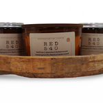 Three hand-poured scented candles in a wooden tray featuring saffron, jasmine, and amberwood scents