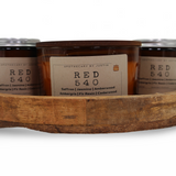 Three hand-poured scented candles in a wooden tray featuring saffron, jasmine, and amberwood scents