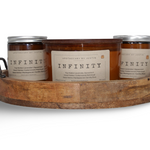 Set of handcrafted candles Australia in amber jars on a wooden tray with labels for home decor