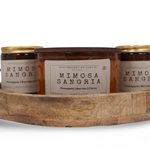 Mimosa Sangria candle online with notes of pineapple, berries, and citrus in a decorative wooden tray