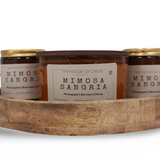 Mimosa Sangria candle online with notes of pineapple, berries, and citrus in a decorative wooden tray