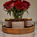 Strong hot-throw candles in a wooden tray with fresh roses for a cozy ambiance