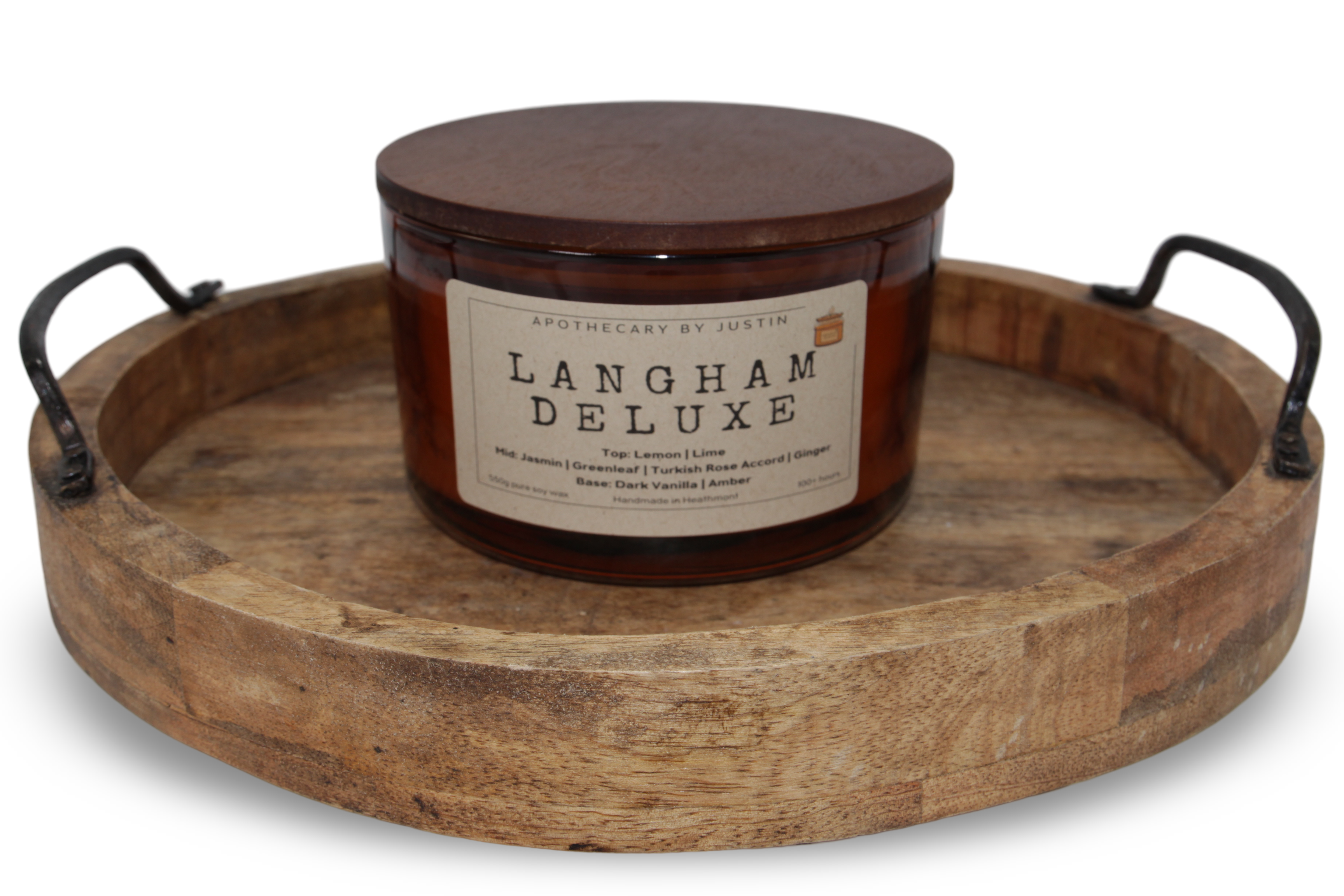 Langham Deluxe strong hot-throw woodsy candle in an amber jar with a wooden lid on a rustic wooden tray