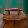 Three unique home fragrance candles in a wooden tray with Jelly Beans scent options