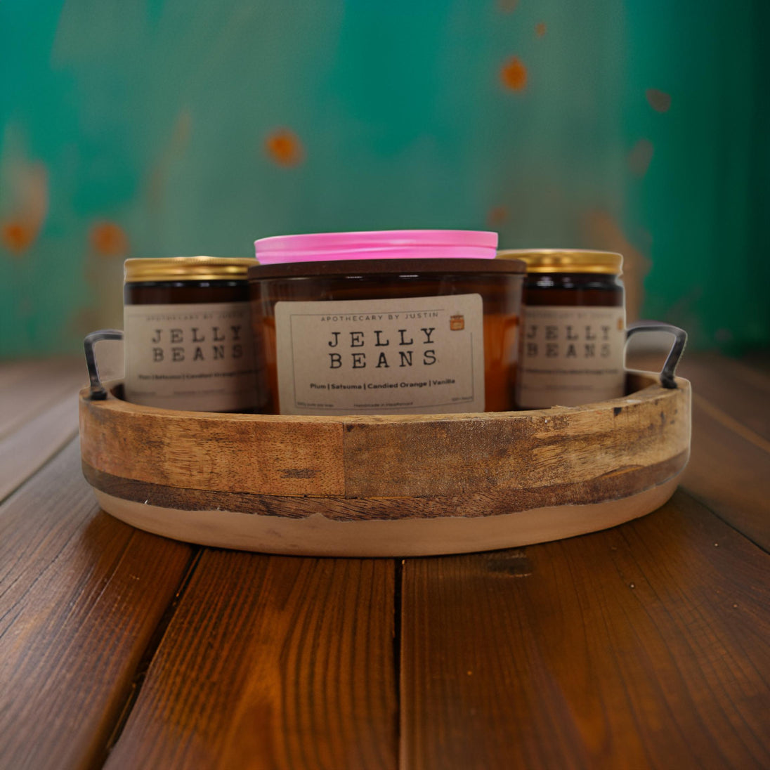 Three unique home fragrance candles in a wooden tray with Jelly Beans scent options
