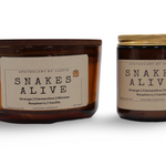 Vegan soy candle gift pack featuring Snakes Alive scents, including Orange, Clementine, and Raspberry Vanilla