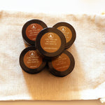 Five sample candles arranged on a calico bag