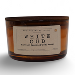Strong hot-throw amber candle in a glass container with a wooden lid and aroma notes of saffron and jasmine