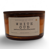 Strong hot-throw amber candle in a glass container with a wooden lid and aroma notes of saffron and jasmine